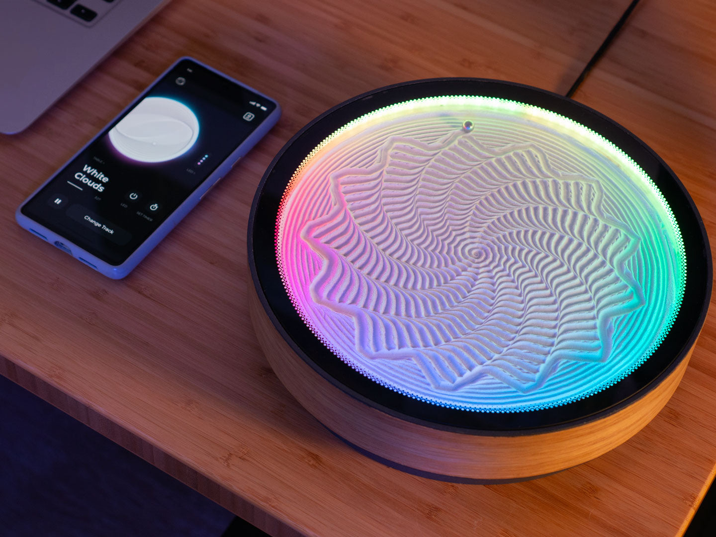 oasis mini on a desk with the android app next to it